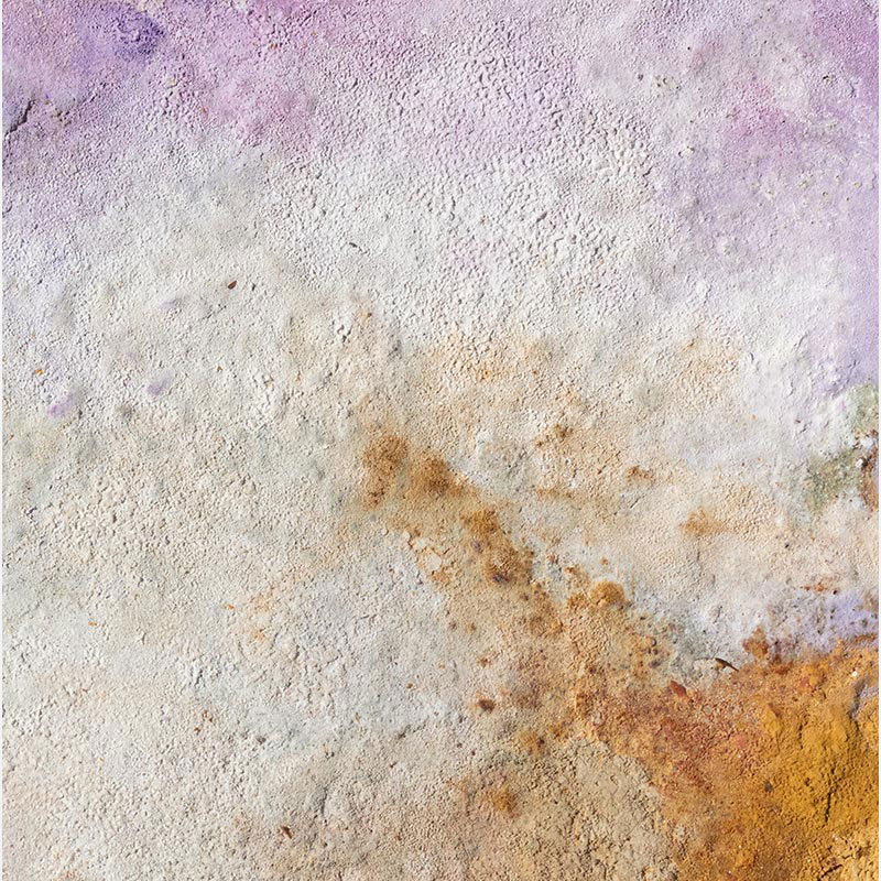 Detail of charcoal and pigment surface on archival paper showing fire-process textures in blue, violet, and ochre. Terra Bruciata 15 by Orazio De Gennaro.