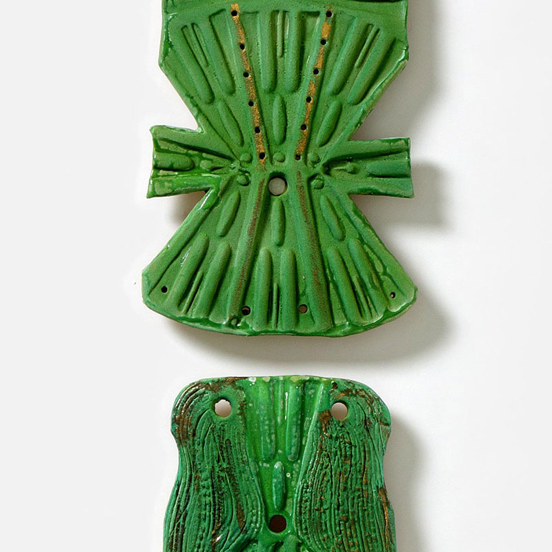Detail of a figurative expressionist totemic sculpture by Giorgio Crisafi. Mainly green colors. Title: Bonds IX