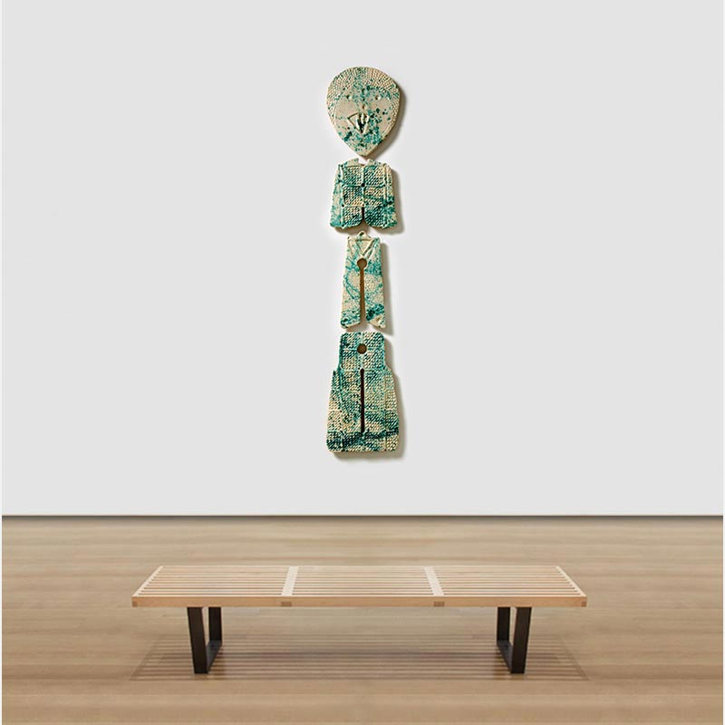 View in a room of a figurative expressionist totemic sculpture by Giorgio Crisafi. Mainly grey, green colors. Title: Bonds XVIII