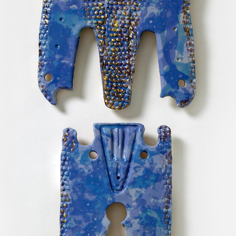 Detail of a figurative expressionist totemic sculpture by Giorgio Crisafi. Mainly blue colors. Title: Bonds IV