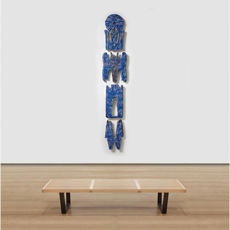 View in a room of a figurative expressionist totemic sculpture by Giorgio Crisafi. Mainly blue colors. Title: Bonds IV