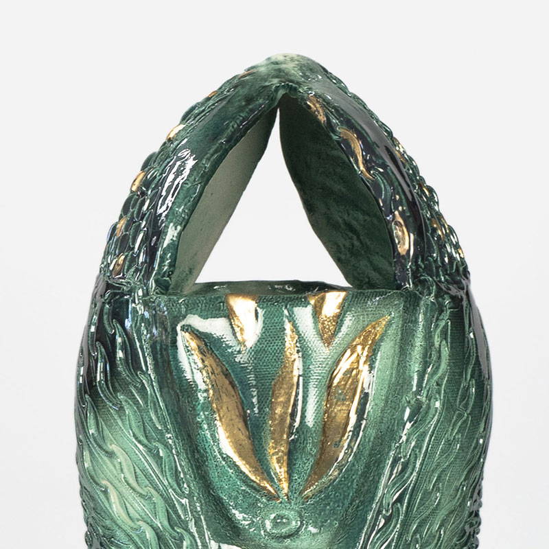 Detail of a figurative expressionist totemic glazed ceramic sculpture by Giorgio Crisafi. Mainly green colors. Title: Apparition II