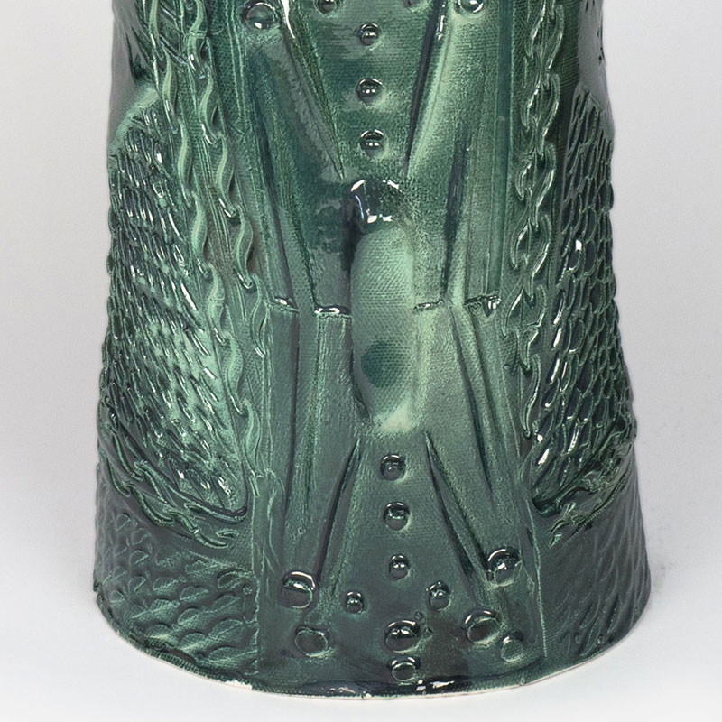 Detail of a figurative expressionist totemic glazed ceramic sculpture by Giorgio Crisafi. Mainly green colors. Title: Apparition II