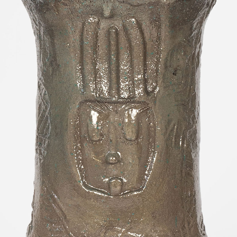 Detail of a figurative expressionist totemic glazed ceramic sculpture by Giorgio Crisafi. Mainly brown colors. Title: Earth Apparition