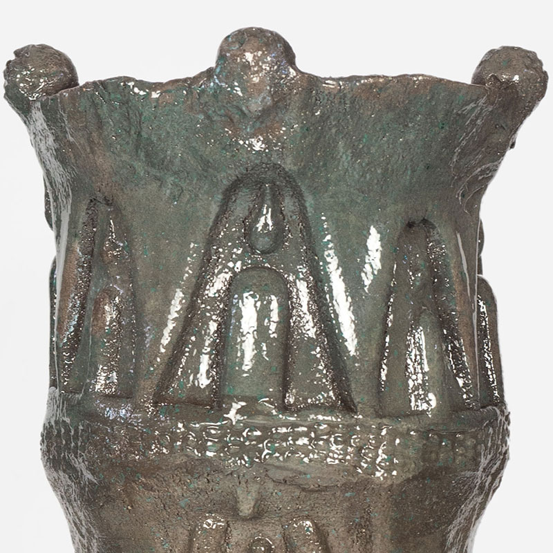 Detail of a figurative expressionist totemic glazed ceramic sculpture by Giorgio Crisafi. Mainly brown colors. Title: Earth Apparition