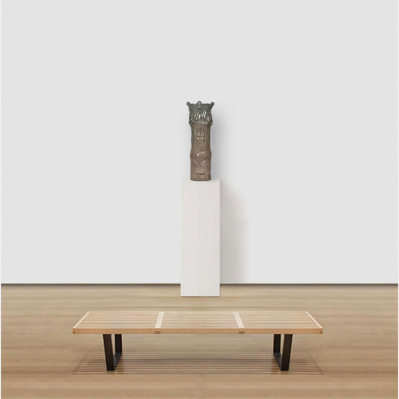 View in a room of a figurative expressionist totemic glazed ceramic sculpture by Giorgio Crisafi. Mainly brown colors. Title: Earth Apparition