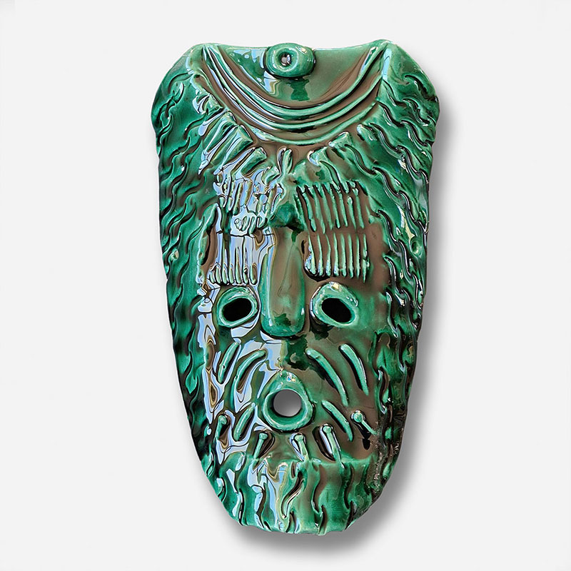 Figurative expressionist relief depicting Green God Mask by Giorgio Crisafi. Mainly green colors. Title: Green God Mask