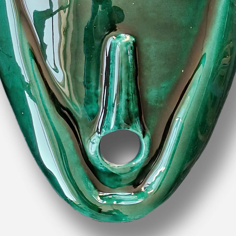 Detail of a figurative expressionist relief depicting Green Goddess Mask by Giorgio Crisafi. Mainly green colors. Title: Green Goddess Mask