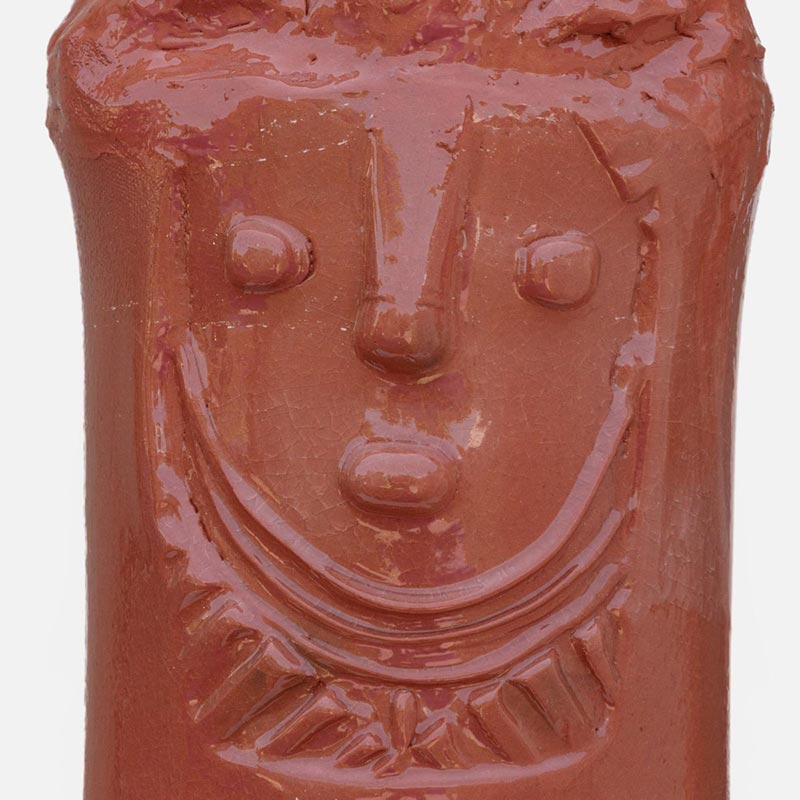 Detail of a figurative ceramic sculpture by Giorgio Crisafi, pink-orange terracotta glaze with gold on nodular scaled crown, Personaggi series. Title: Abitante in Terra II