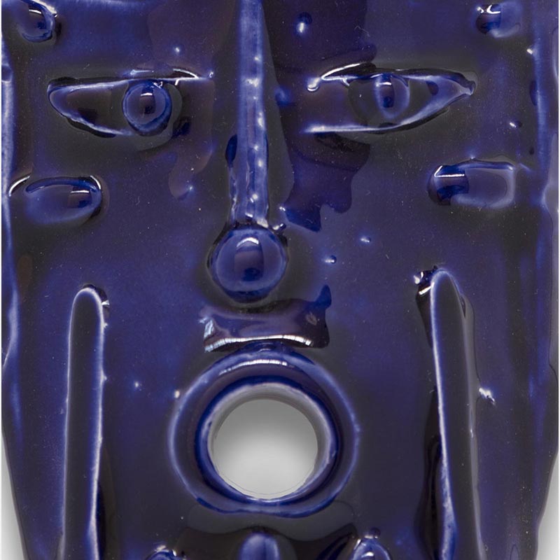 Detail of a figurative ceramic mask sculpture by Giorgio Crisafi, deep ultramarine blue glaze with vertical draped texture, Masks series. Title: Maschera Blu II