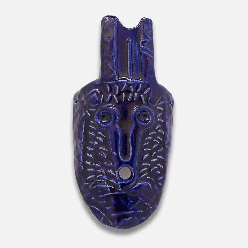 Figurative ceramic mask sculpture by Giorgio Crisafi, cobalt blue glaze on all-over diagonal incised surface, pointed almond form, Masks series. Title: Maschera Blu I